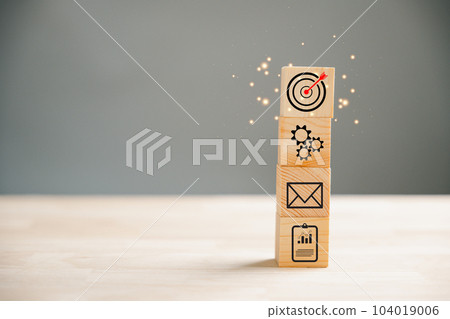 Action Plan, Goal, and Target icons on a wooden block cude step. Success and business target concept. Project management and company strategy symbolize achievement. 104019006