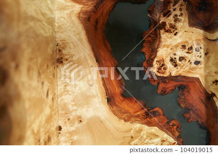 The texture of a wooden table covered with epoxy resin. Top view of a tree as a background with space to copy. High quality photo 104019015