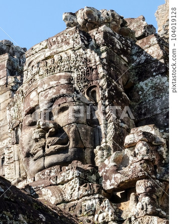 View of stone human faces, a notable feature on the towers of Cambodia's Khmer Bayon Temple. View of stone human faces, a notable feature on the towers of Cambodia's Khmer Bayon Temple. 104019128
