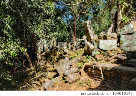 Ancient ruins of the Khmer Empire in a Cambodian forest on a sunny day. Ancient ruins of the Khmer Empire in a Cambodian forest on a sunny day. 104019142