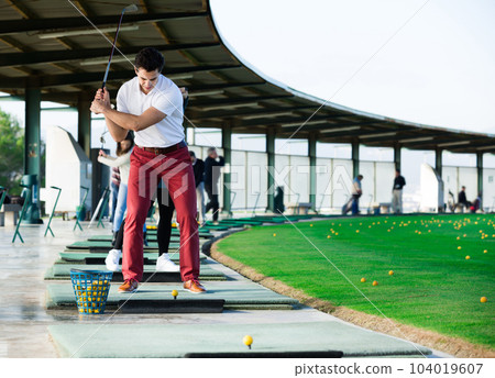 Young golfer is ready for play at golf course Young golfer is ready for play at golf course 104019607