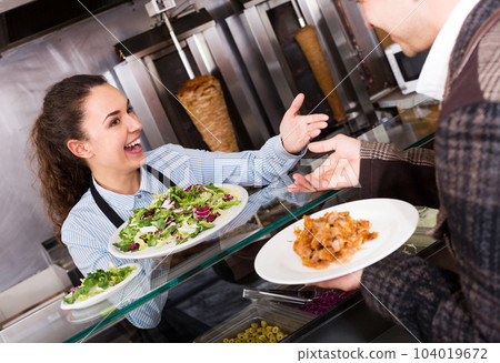 Girl and satisfied customer buying kebab 104019672