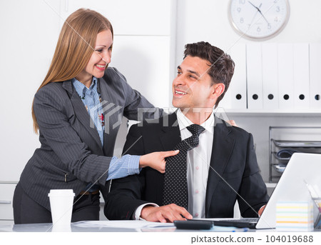Businesswoman seducing male colleague 104019688