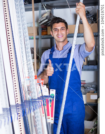 Smiling sellerman is choosing ceiling for client Smiling sellerman is choosing ceiling for client 104019701
