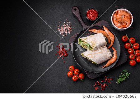 Delicious fresh roll with shrimps, tomatoes, lettuce and cucumber in pita bread Delicious fresh roll with shrimps, tomatoes, lettuce and cucumber in pita bread 104020662