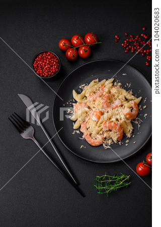 Delicious fresh penna pasta with shrimp, sauce, cheese, salt and spices 104020683