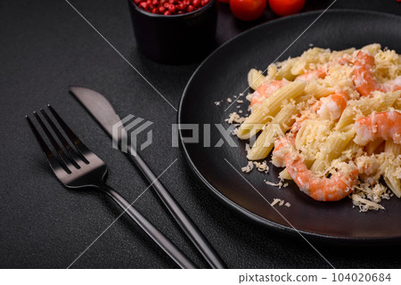 Delicious fresh penna pasta with shrimp, sauce, cheese, salt and spices 104020684