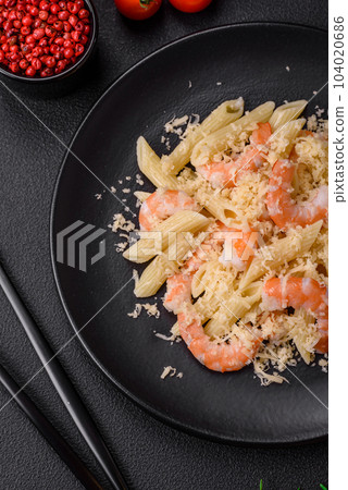 Delicious fresh penna pasta with shrimp, sauce, cheese, salt and spices 104020686