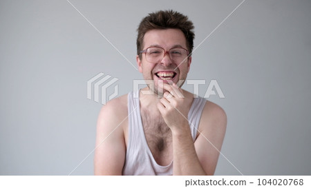 A sarcastic man in big glasses mockingly laughs and points his finger at the camera A sarcastic man in big glasses mockingly laughs and points his finger at the camera 104020768