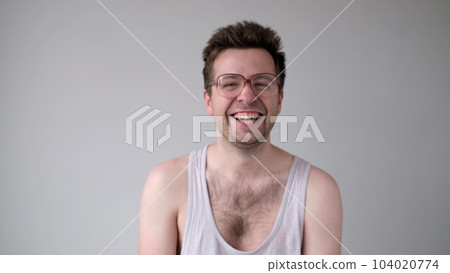 European man with big glasses is laughing foolishly. 104020774
