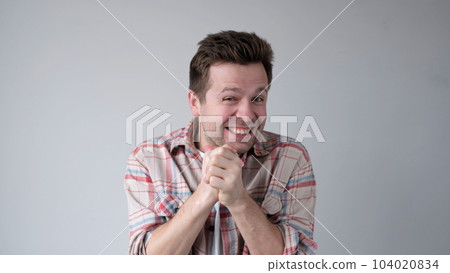 European young man is happily rubbing his hands 104020834