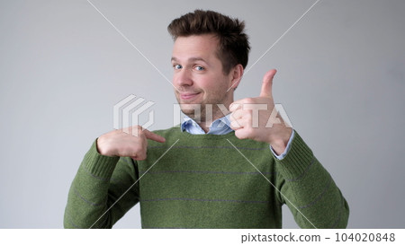 The European young man proudly points at himself, saying I am good with myself 104020848