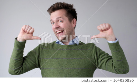 The European young man proudly points at himself, saying I am good with myself 104020850