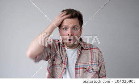 European young person, in bewilderment, grabs their head and asks how could such a thing happen European young person, in bewilderment, grabs their head and asks how could such a thing happen 104020905
