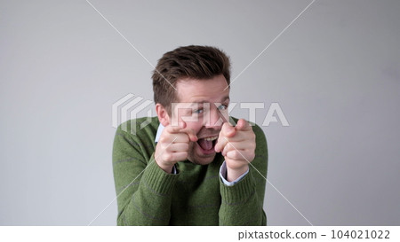A European young man points with his fingers at the camera, saying I choose you. You are good 104021022