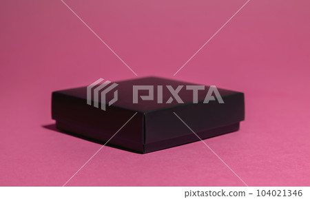 Front view, black gift box on pink background. Front view, black gift box on pink background. 104021346