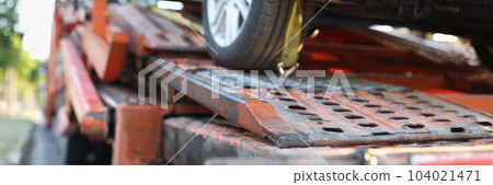 Broken car stands on tow truck closeup 104021471