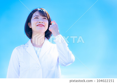 blue sky and woman in white coat 104022151