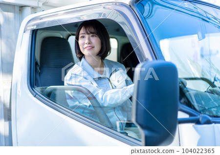 Female driver driving a truck 104022365
