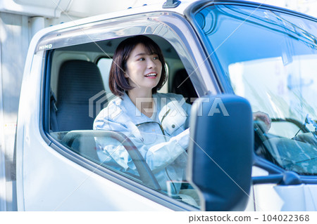 Female driver driving a truck 104022368