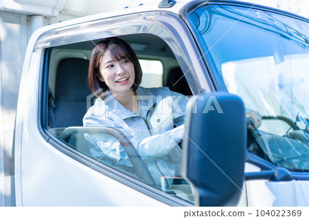 Female driver driving a truck 104022369