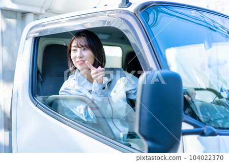 Female driver driving a truck Female driver driving a truck 104022370