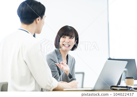 Male and female office workers meeting Male and female office workers meeting 104022437