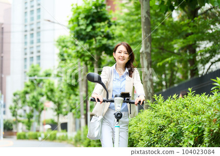 Female driving an electric kickboard Female driving an electric kickboard 104023084