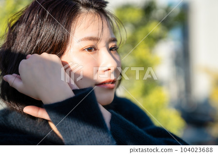 Profile of a woman wearing black knit Profile of a woman wearing black knit 104023688