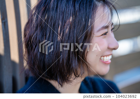 Profile of a woman wearing black knit Profile of a woman wearing black knit 104023692