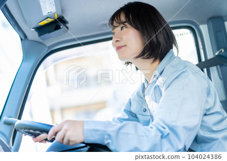 Female driver driving a truck 104024386