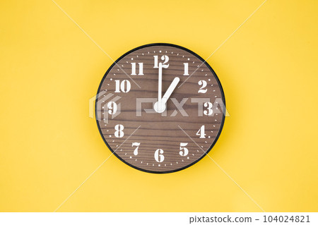 The Retro wooden clock at 1 O' clock on yellow color background. 104024821