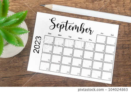 The September 2023 Monthly calendar for 2023 year with wooden pencil on wooden table. 104024863