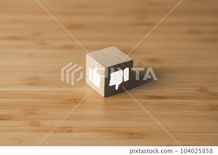 Wooden block of thumb up and thumb down. meaning like and unlike. customer satisfaction concept. Wooden block of thumb up and thumb down. meaning like and unlike. customer satisfaction concept. 104025858