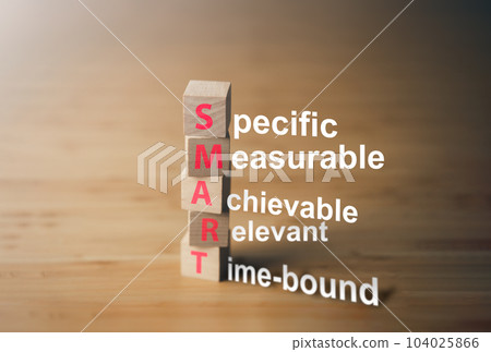 Wooden block of SMART goal. Specific, Achievable, Measurable, Relevant and Time bound. Business tool concept. 104025866