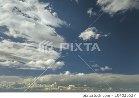White puffy cumulus clouds on summer blue sky White puffy cumulus clouds on summer blue sky 104026527