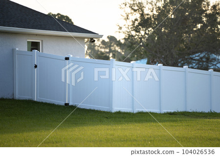 White plastic fence for back yard protection and privacy 104026536