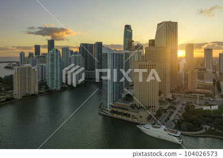 View from above of high skyscraper buildings in downtown district of Miami Brickell in Florida, USA at sunset. American megapolis with business financial district at nightfall 104026573