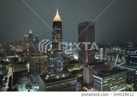 View from above of brightly illuminated high skyscraper buildings in downtown district of Atlanta city in Georgia, USA. American megapolis with business financial district at night 104026612
