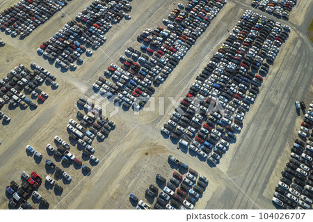View from above of big parking lot with parked used cars after accident ready for sale. Auction reseller company selling secondhand broken vehicles for repair 104026707