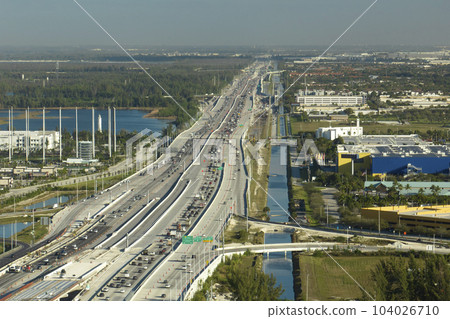 View from above of american wide freeway in Miami, Florida with dense traffic of driving cars during rush hour. USA transportation infrastructure concept 104026710