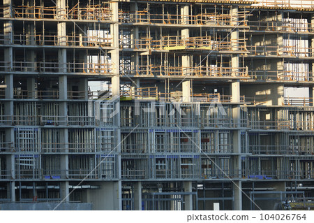 Tower cranes and frame structure of high residential apartment buildings at construction site. Real estate development Tower cranes and frame structure of high residential apartment buildings at construction site. Real estate development 104026764