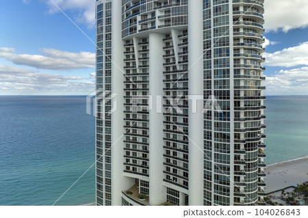 Sunny Isles Beach city with luxurious highrise hotels and condo buildings on Atlantic ocean shore. American tourism infrastructure in southern Florida 104026843