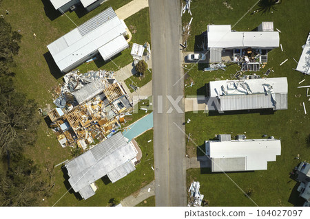 Severely damaged by hurricane Ian houses in Florida mobile home residential area. Consequences of natural disaster Severely damaged by hurricane Ian houses in Florida mobile home residential area. Consequences of natural disaster 104027097