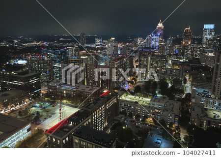 Night urban landscape of downtown district of Atlanta city in Georgia, USA. Skyline with brightly illuminated high skyscraper buildings in modern american megapolis 104027411