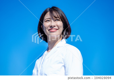 blue sky and woman in white coat 104028094