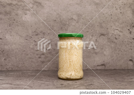 Preserved Celery Root Salad In Glass Jar With Screw Metal Cap On Shelf. Apium Graveolens, Shredded And Pickled Celery Crops, Tuber. Culinary. Vitamins C, K, A, E, PP, B. Copy Space, Horizontal Plane Preserved Celery Root Salad In Glass Jar With Screw Metal Cap On Shelf. Apium Graveolens, Shredded And Pickled Celery Crops, Tuber. Culinary. Vitamins C, K, A, E, PP, B. Copy Space, Horizontal Plane 104029407