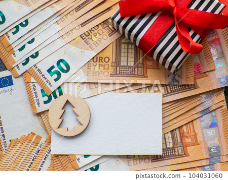 Copy space with christmas tree on the background of fifty euros banknotes Copy space with christmas tree on the background of fifty euros banknotes 104031060