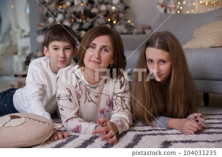 Mother, daughter and son at Christmas time 104031235