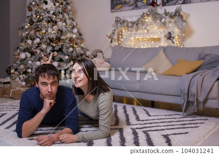 Happy young couple near Christmas tree  104031241
